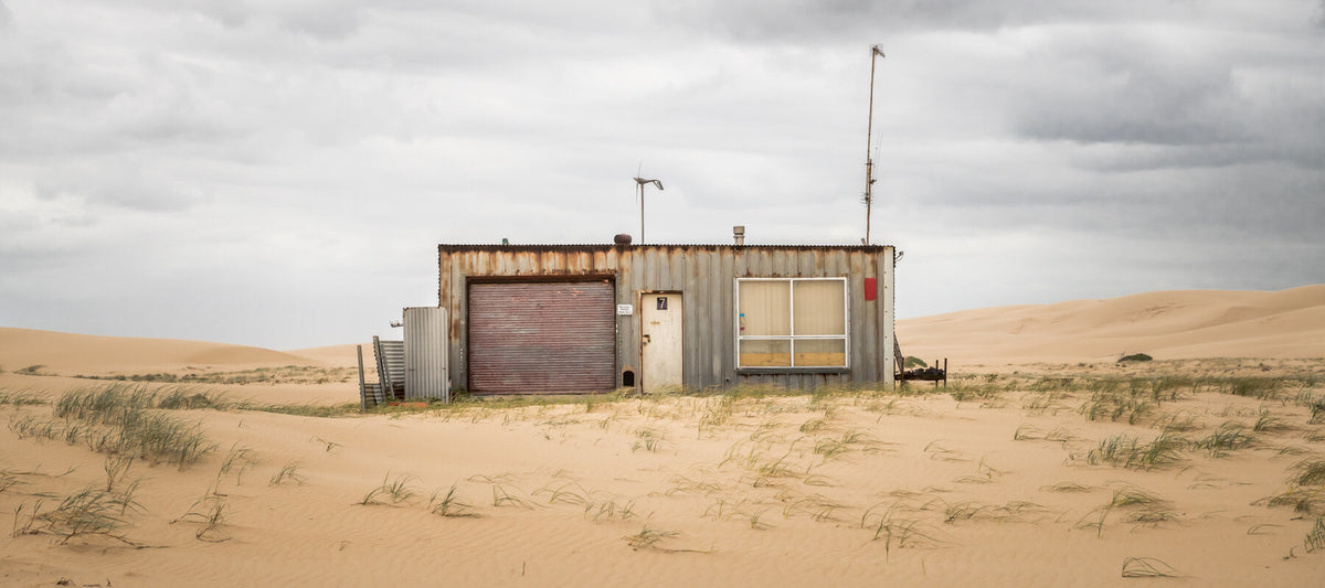 A weathered corrugated-iron shack at Tin City in the Stockton Bight dunes, Port Stephens NSW