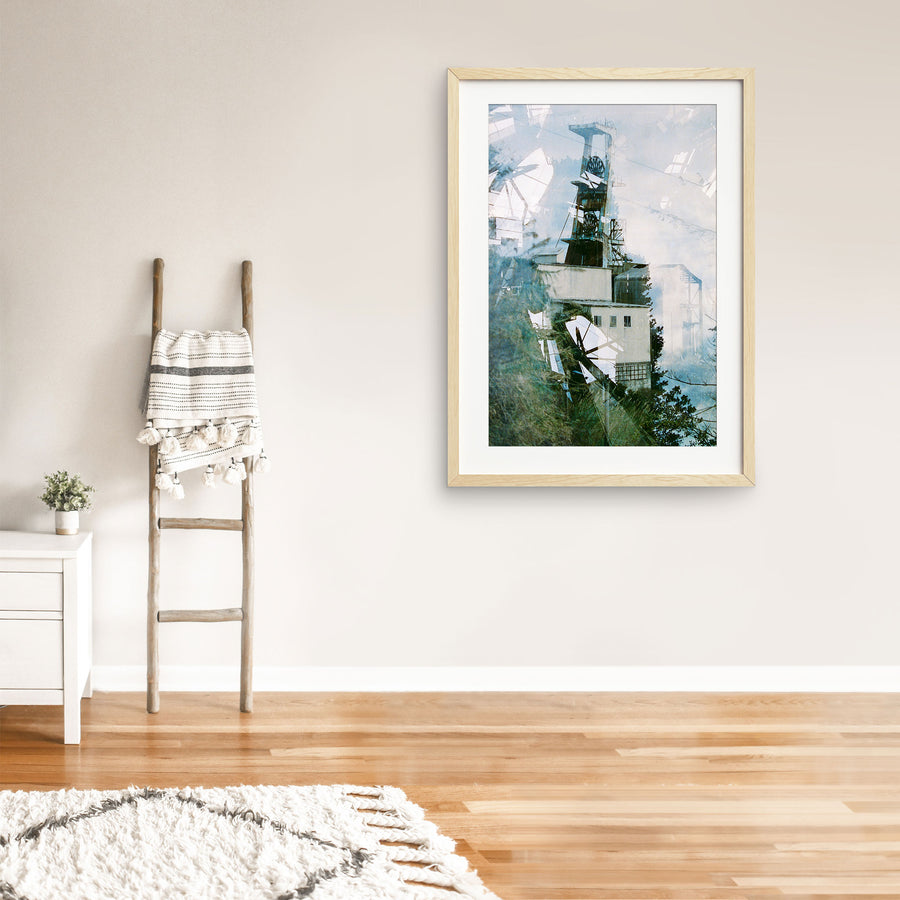 Multiple exposures stack the steel headframe and spoked winding wheels of Ikeshima Coal Mine above a rendered engine house, with blurred foliage across the foreground and a corrugated metal structure to the right.