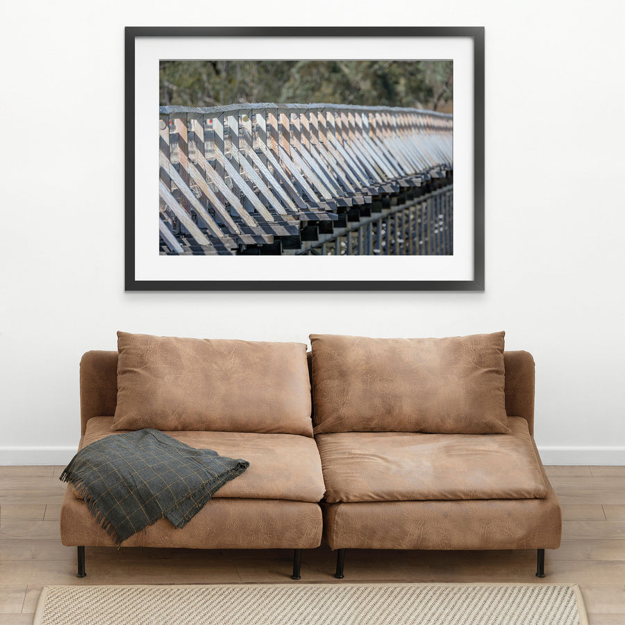 Close view along the weathered white-painted timber side railing of McKillops Bridge in the Deddick Valley, black-framed print displayed in situ on a wall.