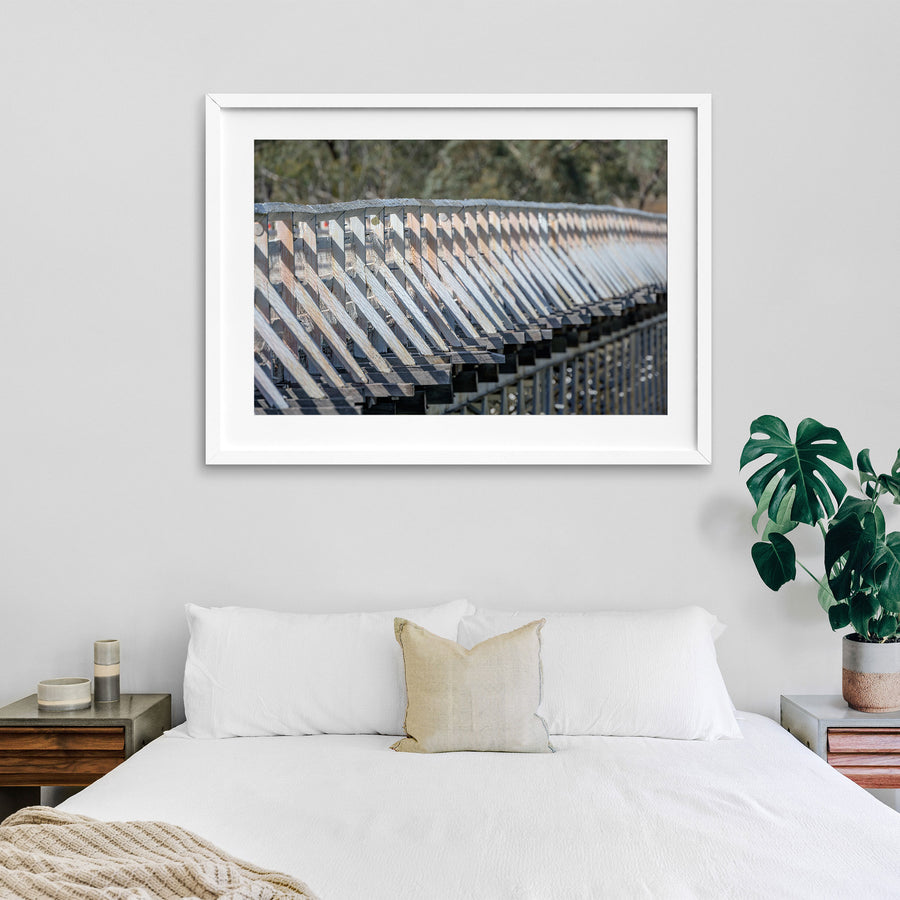 Close view along the weathered white-painted timber side railing of McKillops Bridge in the Deddick Valley, white-framed print displayed in situ on a wall.
