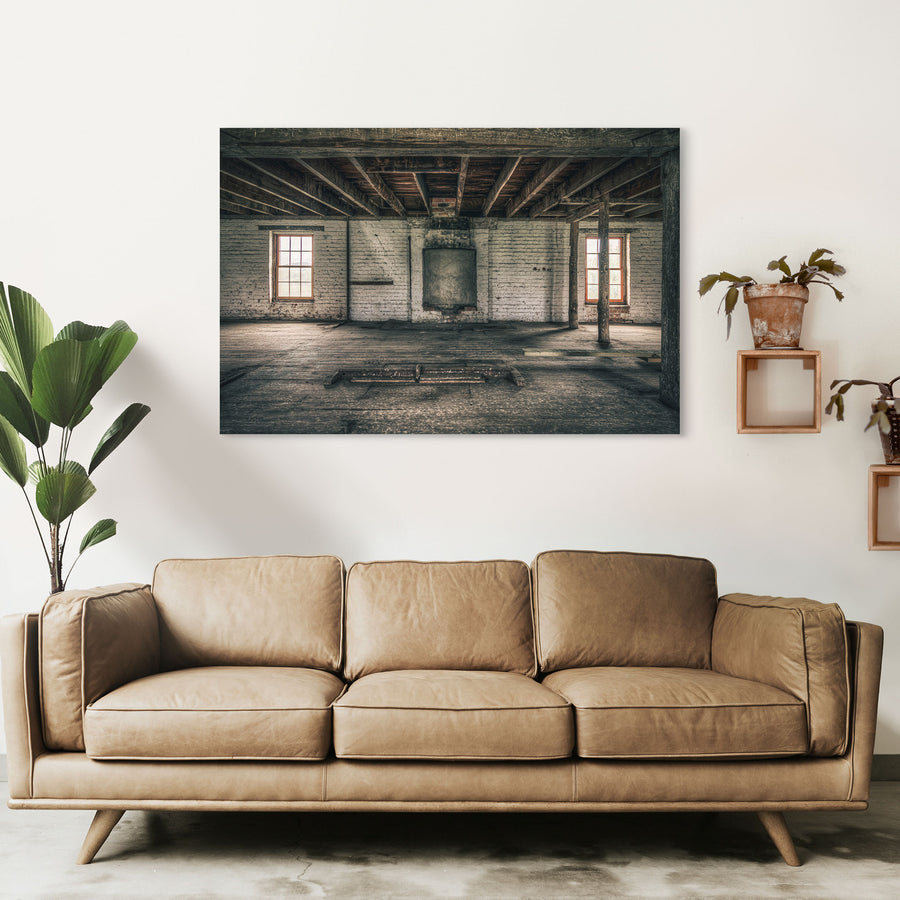 Upper room at Jembaicumbene mill, whitewashed brick walls and two sash windows over a bare timber floor.