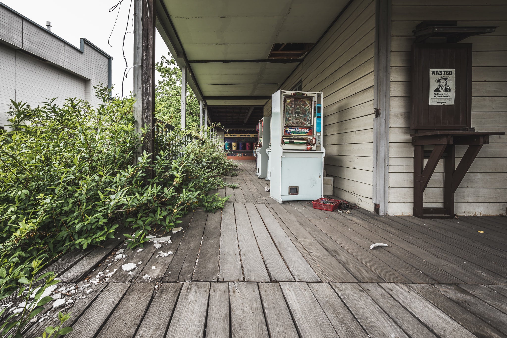 Verandah at Western Village, a weathered timber verandah runs along a western-style clapboard building.