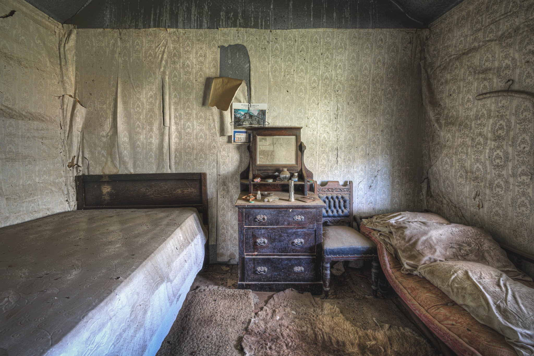 Side Bedroom at Woolla, two single beds fill the room, pushed against opposite walls with a timber dresser wedged.