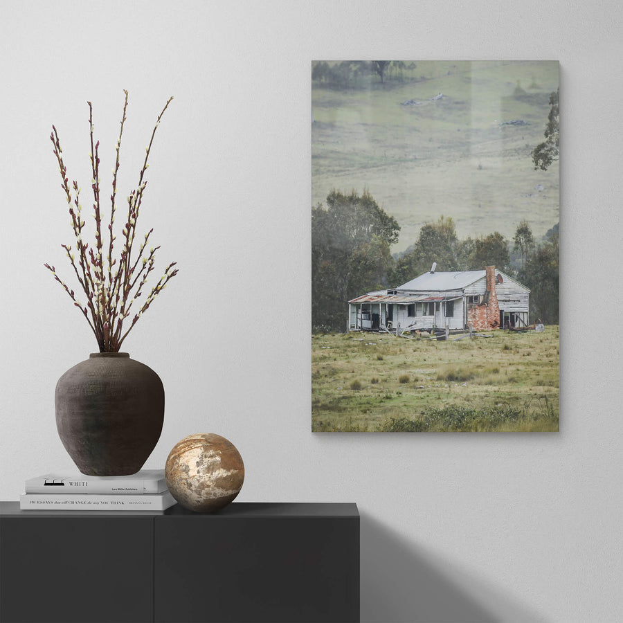 Home In The Valley at A Place to Call Home, a weatherboard farmhouse sits alone in open grazing country.