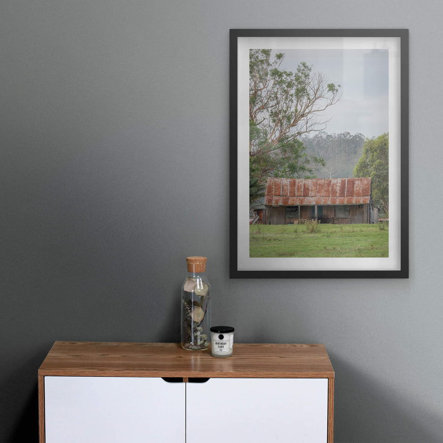 Hunter Hilltop at A Place to Call Home, a low timber shed sits in open green pasture beneath an overcast sky.