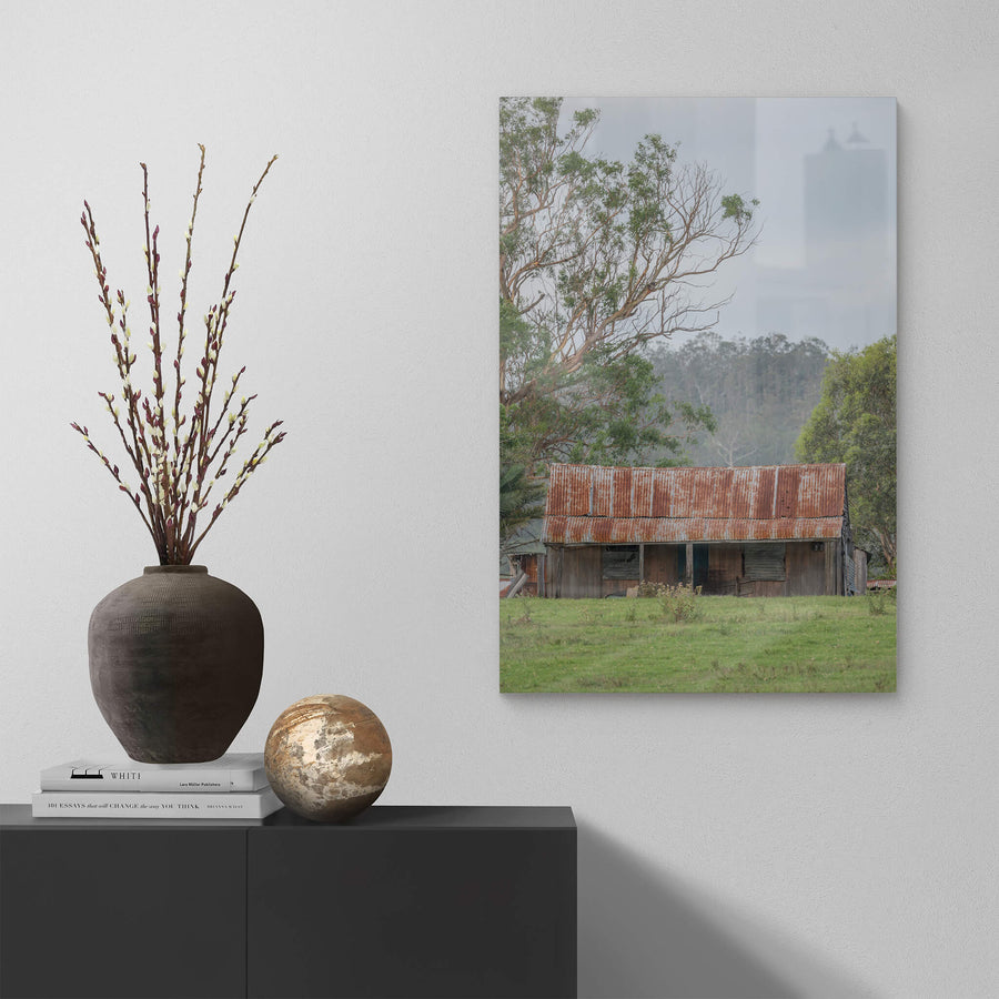 Hunter Hilltop at A Place to Call Home, a low timber shed sits in open green pasture beneath an overcast sky.