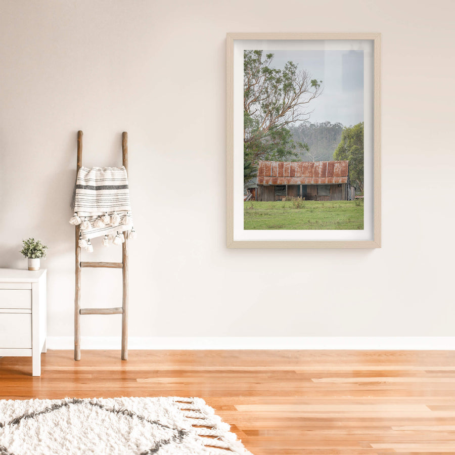 Hunter Hilltop at A Place to Call Home, a low timber shed sits in open green pasture beneath an overcast sky.