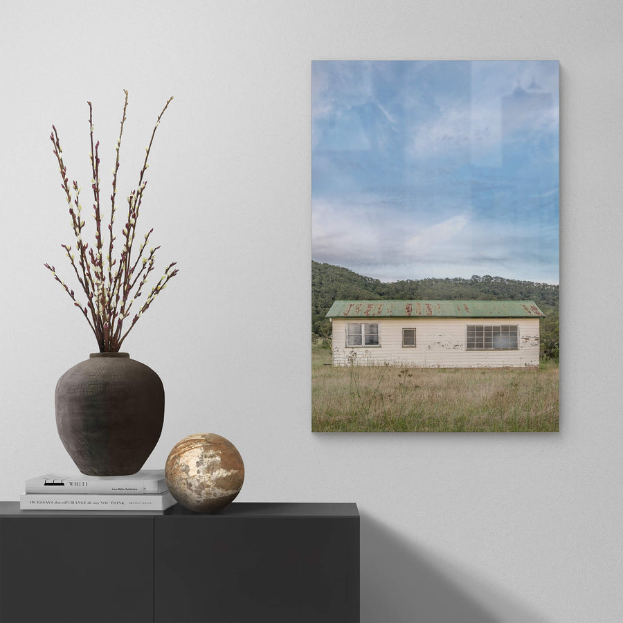 Hunter Shack at A Place to Call Home, a single-storey weatherboard building sits low in a clearing of dry grass and thistles.