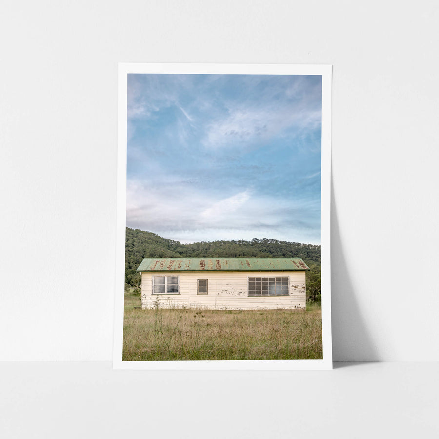 Hunter Shack at A Place to Call Home, a single-storey weatherboard building sits low in a clearing of dry grass and thistles.