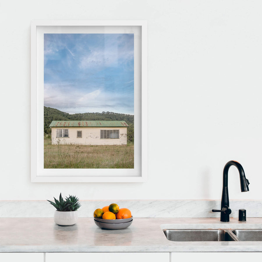 Hunter Shack at A Place to Call Home, a single-storey weatherboard building sits low in a clearing of dry grass and thistles.