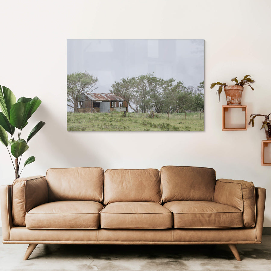 Rocky Hall Hills Hut at A Place to Call Home, a small rural structure sits on a low green rise near Rocky Hall Hills.