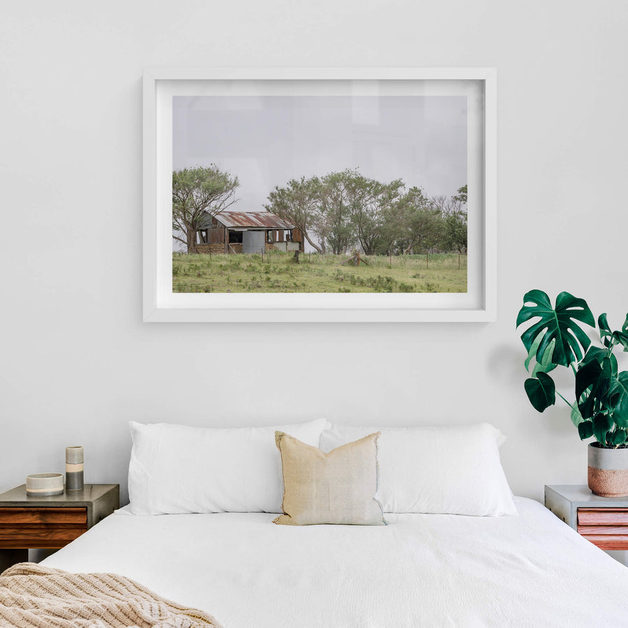 Rocky Hall Hills Hut at A Place to Call Home, a small rural structure sits on a low green rise near Rocky Hall Hills.
