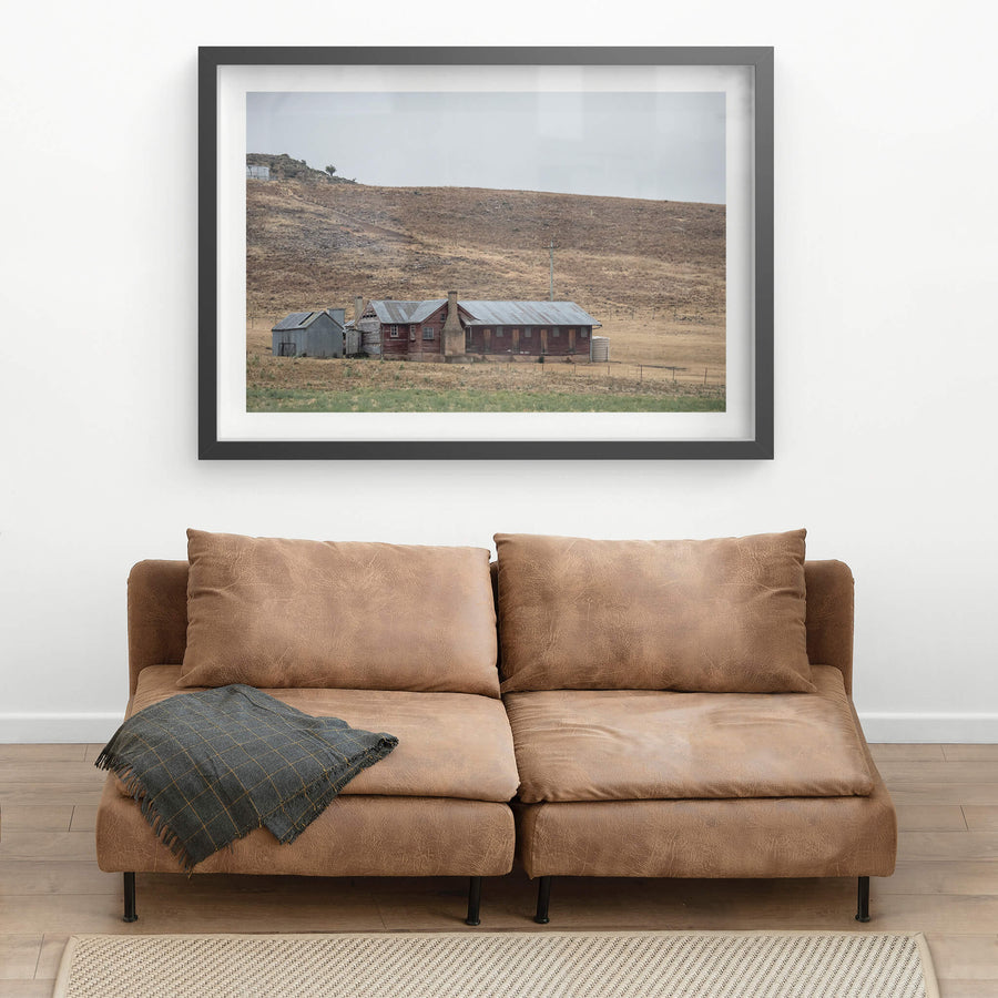 Shearers Quarters at A Place to Call Home, a low timber homestead sits against a bare hillside in rural New South Wales.