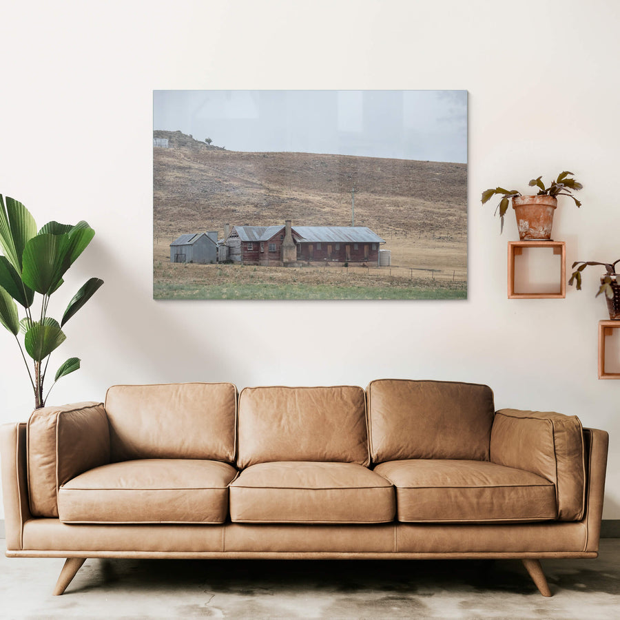 Shearers Quarters at A Place to Call Home, a low timber homestead sits against a bare hillside in rural New South Wales.