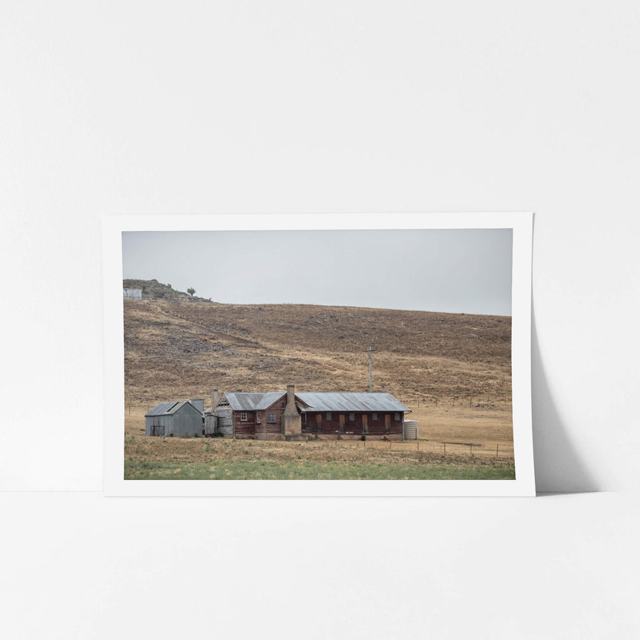 Shearers Quarters at A Place to Call Home, a low timber homestead sits against a bare hillside in rural New South Wales.