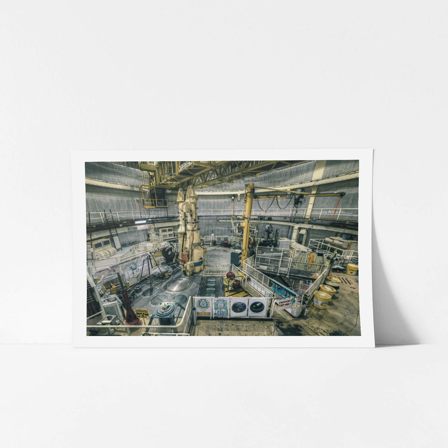 Top Plate Beneath Polar Crane at ANSTO HIFAR, yellow lab coats hang on the mesh walls of the right walkway, worn.