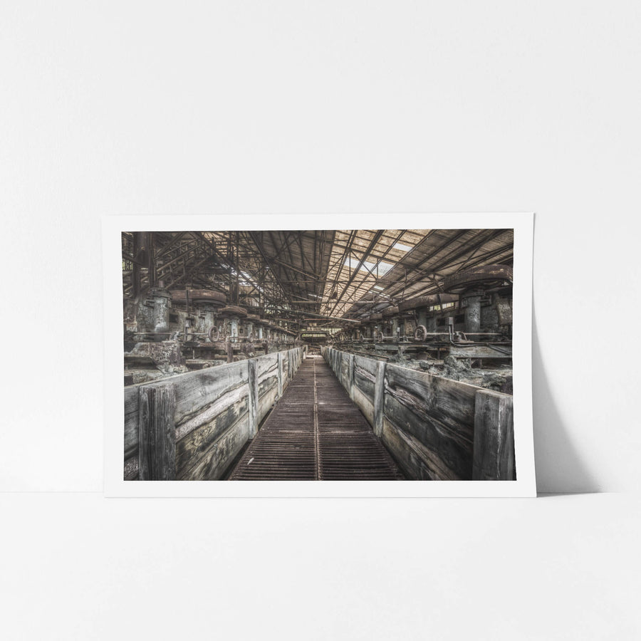 Froth Flotation Cells at Ashio Copper Mine, a narrow metal grating walkway runs between two rows of timber-lined flotation.