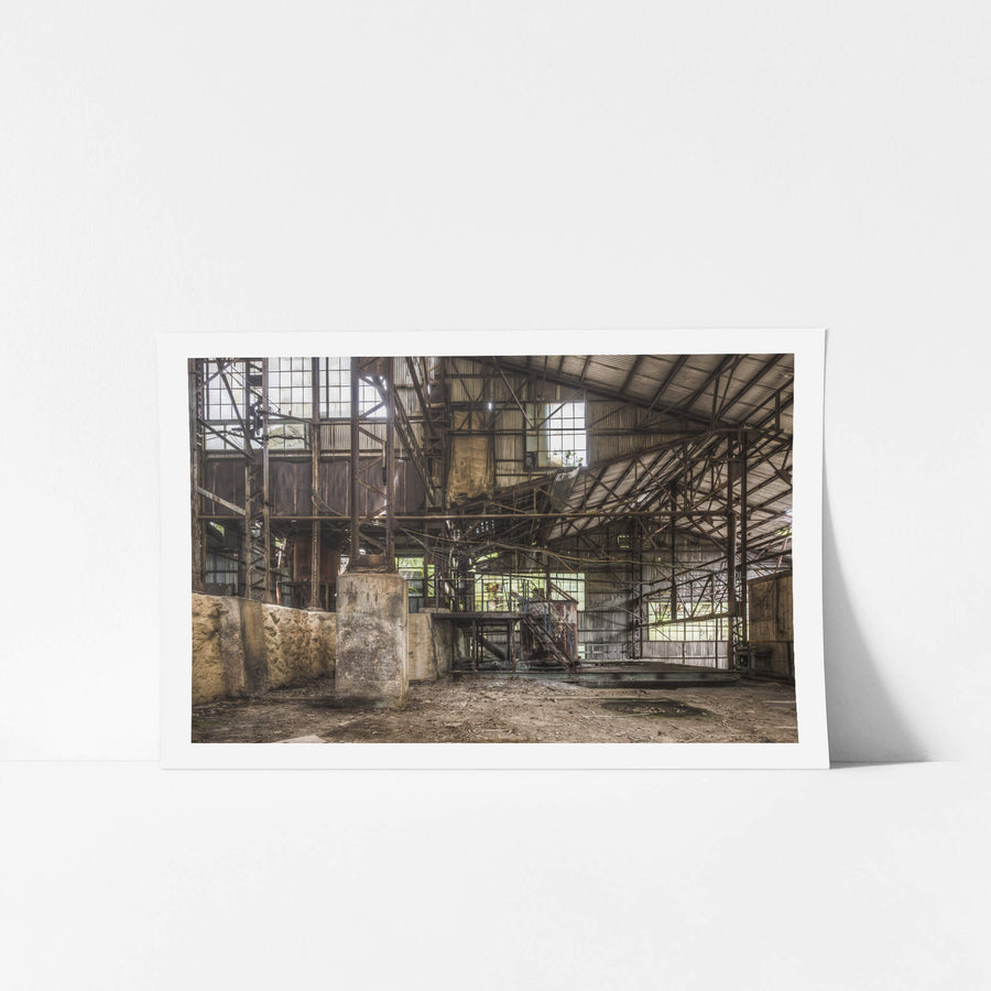 Holding Area at Ashio Copper Mine, concrete plinths rise from a dirt floor inside a corrugated iron shed.