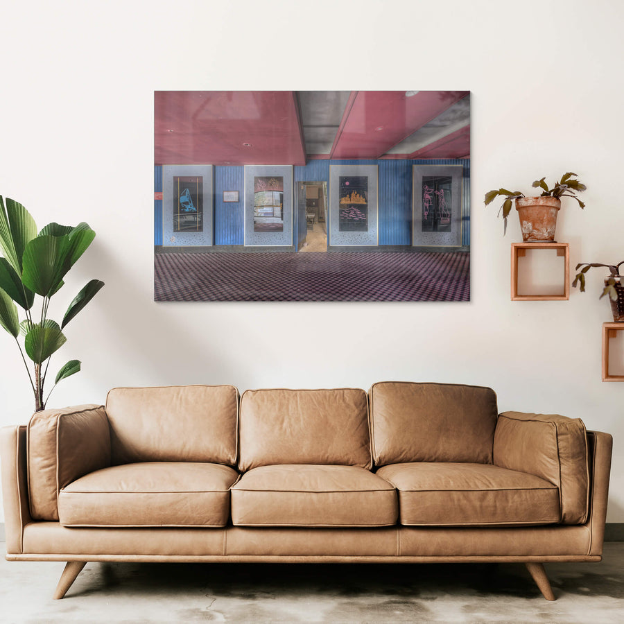 Foyer Art at Bankstown RSL, five framed artworks line the foyer wall, mounted on blue timber panelling punctuated.