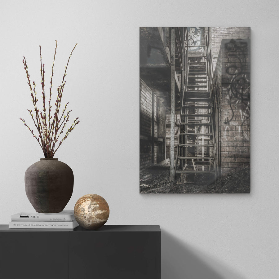 Stairs To Level Two at Bathurst Gasworks, a steel staircase climbs between brick walls, bolted to a narrow column.