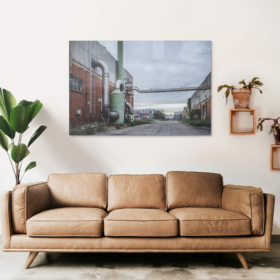 Chemical Plant at Bradmill Denim, a green dust extraction unit stands bolted to the red brick facade of a factory building.