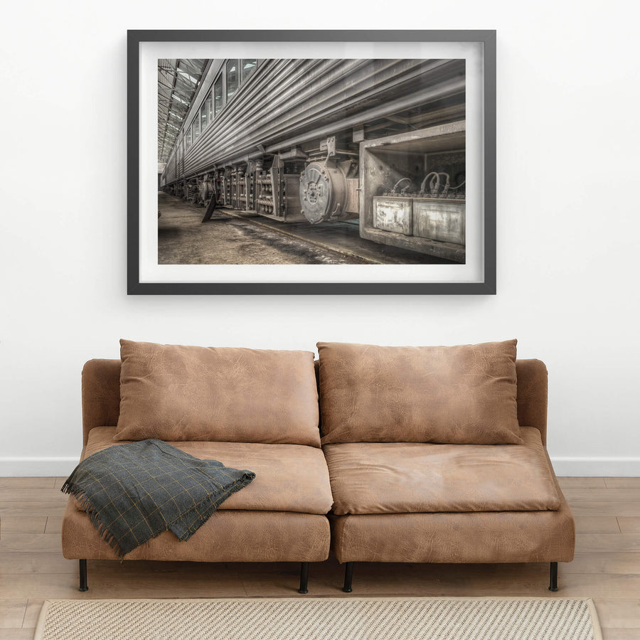 Batteries at Eveleigh Paint Shop, the underside of a stainless steel interurban carriage fills the frame.