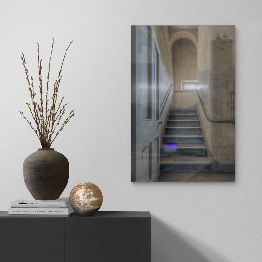 Flare at Female Ward 9 & 10, a narrow stairwell climbs between plaster walls stained grey and ochre with damp.