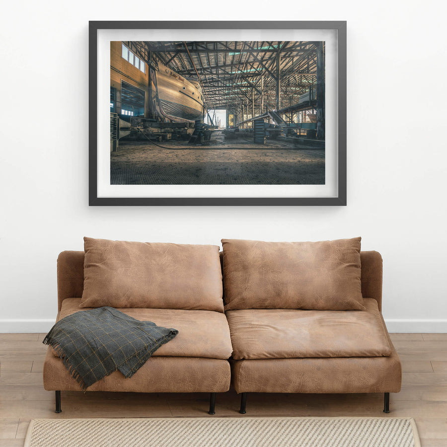 Beneath the Boat at Halvorsens Boat Yard, a timber-hulled vessel sits on steel cradle blocks inside the main shed.