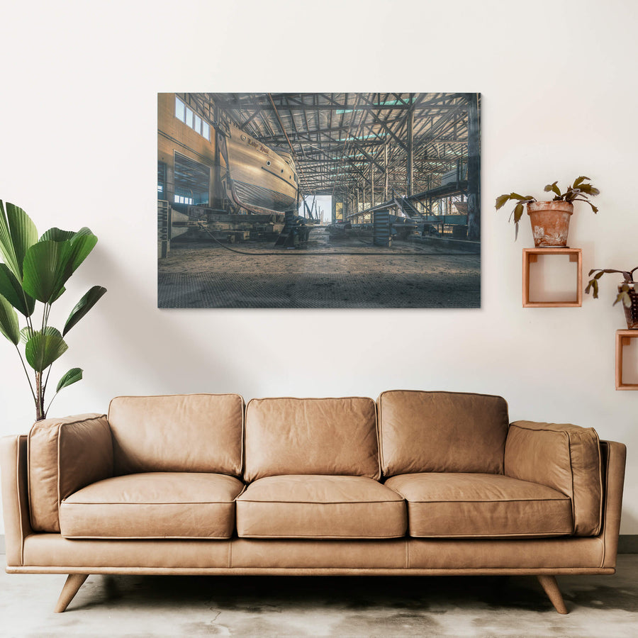 Beneath the Boat at Halvorsens Boat Yard, a timber-hulled vessel sits on steel cradle blocks inside the main shed.