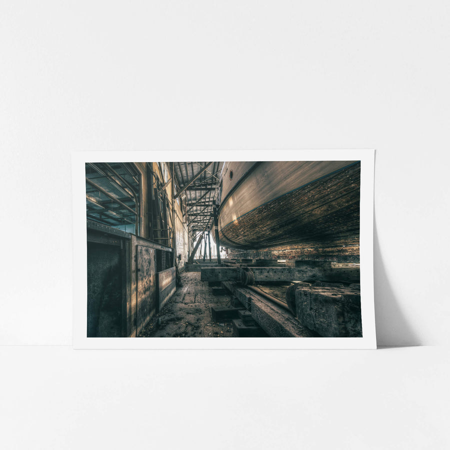 On Rail at Halvorsens Boat Yard, a timber hull sits cradled on steel rails inside the shed at Halvorsens Boat Yard.