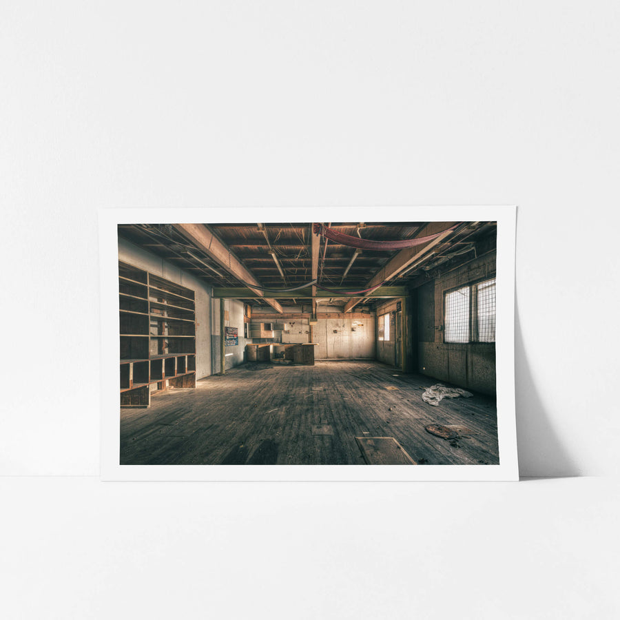 Storeroom at Halvorsens Boat Yard, a wide timber floor stretches across the storeroom, every plank grey with dust and grit.