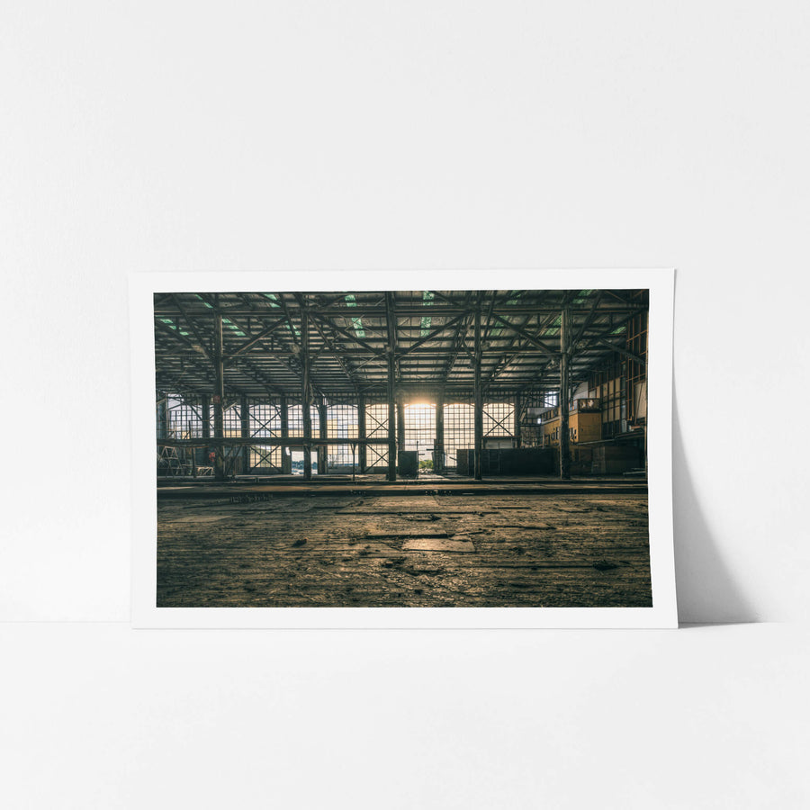 Workshop Sunset at Halvorsens Boat Yard, low sun pushes through the enormous gridded windows at the far end of the workshop.
