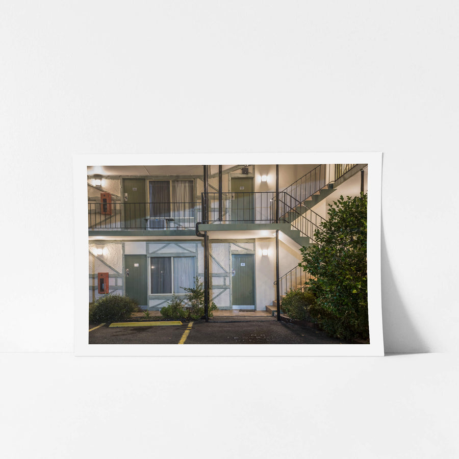 Ascot Motor Inn at Hotel Motel 101, two storeys of rendered blockwork and green-painted timber doors.