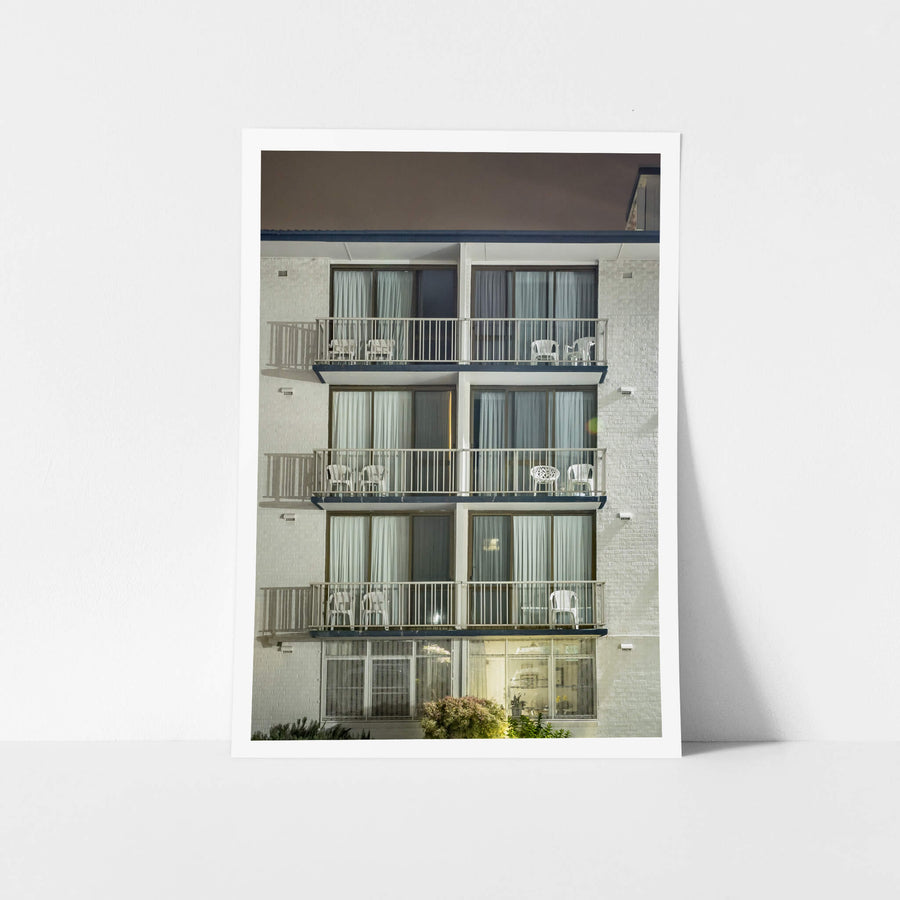 Boat Harbour Motel at Hotel Motel 101, three storeys of white-painted brick rise flat against the night sky.