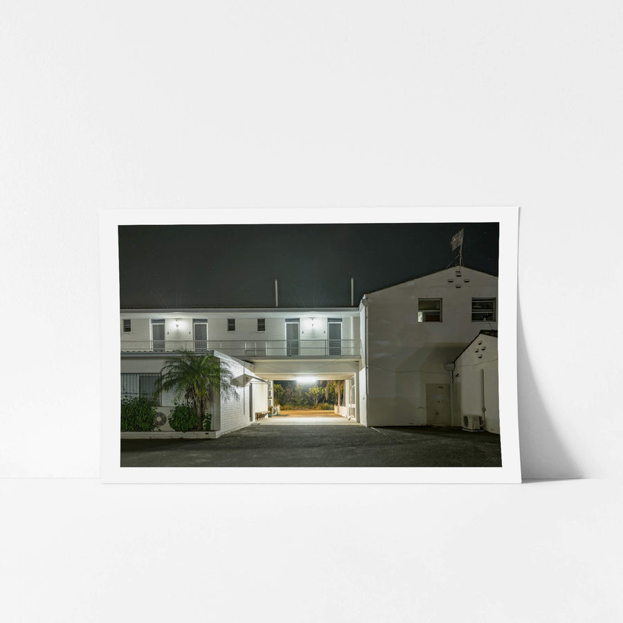 Ettalong Beach Motel at Hotel Motel 101, a two-storey motel block sits under a dark sky, its white-painted brick washed.