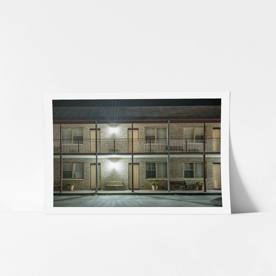 New Inn Motel at Hotel Motel 101, two storeys of brown brick face an empty car park.
