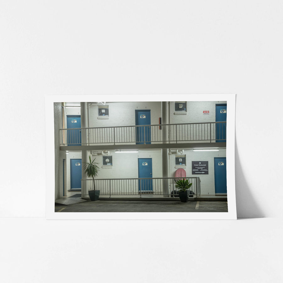 Ocean Front Motel At Blue Bay at Hotel Motel 101, two storeys of painted blockwork and blue steel doors.