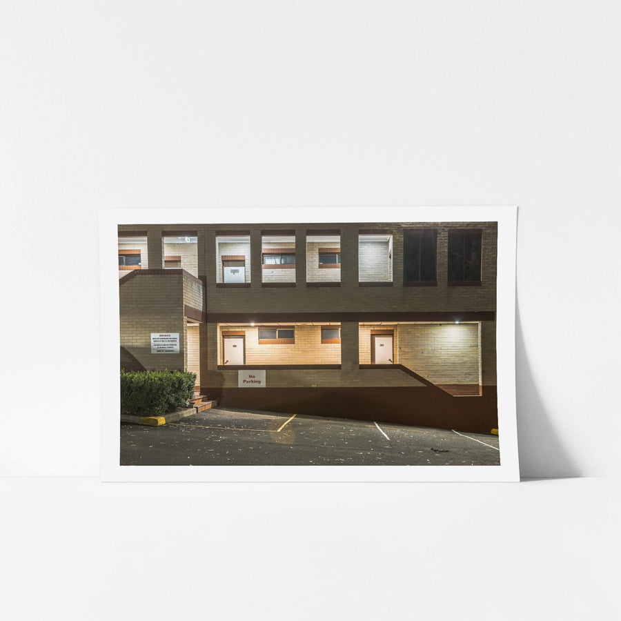 Penrith Valley Inn at Hotel Motel 101, two storeys of cream and brown brick rise above an empty car park.