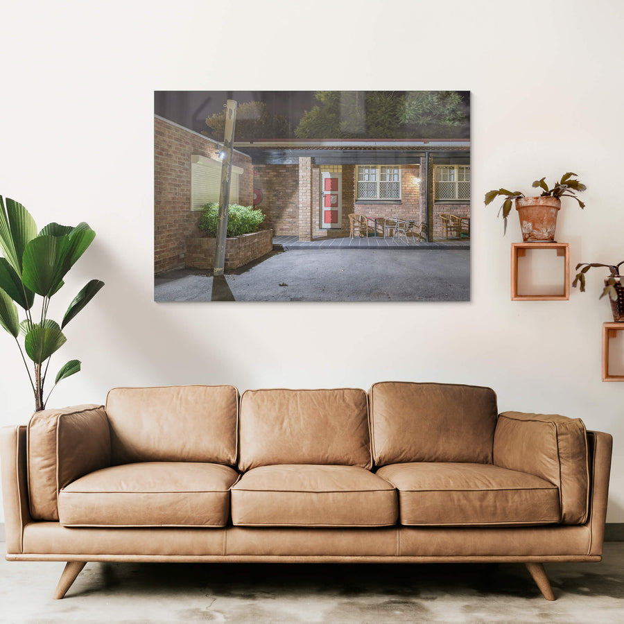 Richmond Inn at Hotel Motel 101, a single floodlight on a timber power pole throws hard white light across the car park.