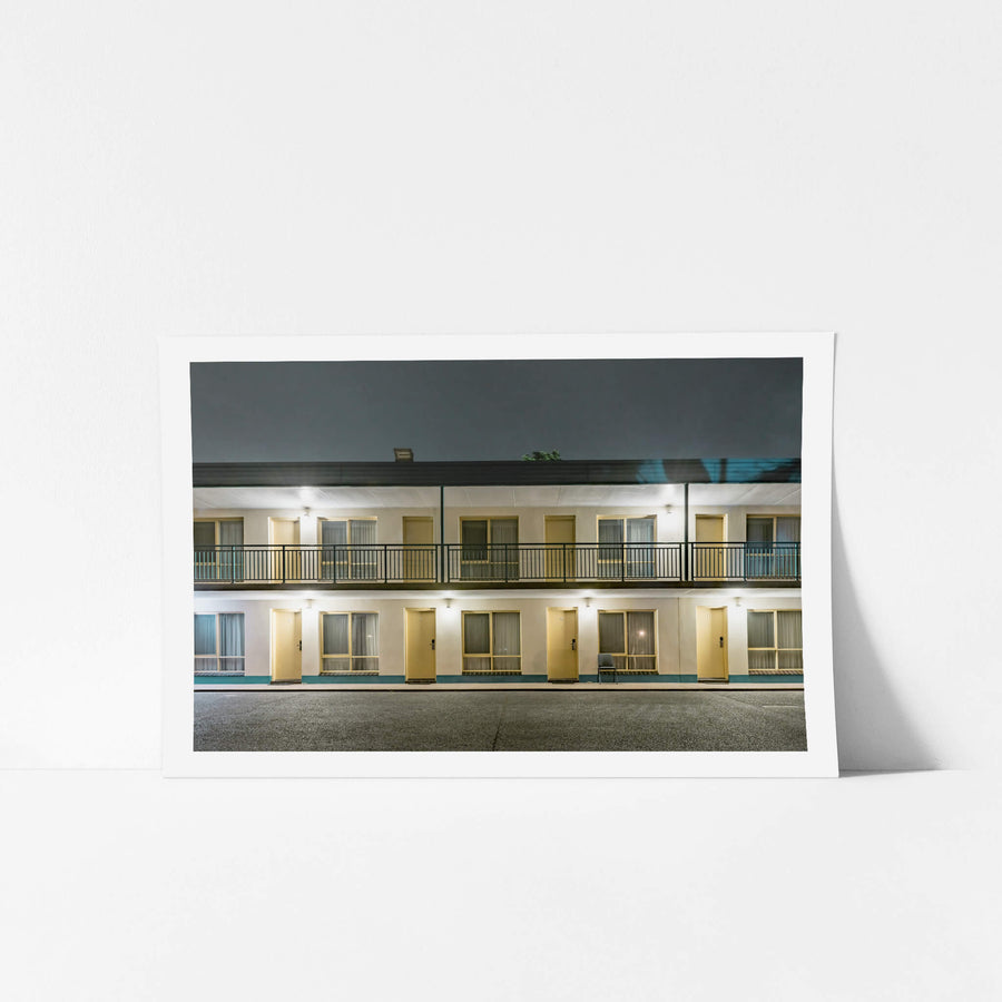 Shellharbour Resort at Hotel Motel 101, two storeys of rendered concrete and cream-painted doors face an empty car park.