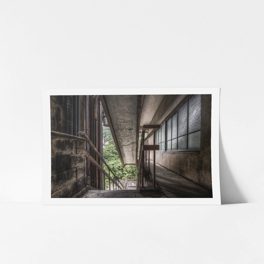 Exterior Fire Exit at Kinugawa Kan, a concrete overhang presses low above an exterior corridor on the upper floors.