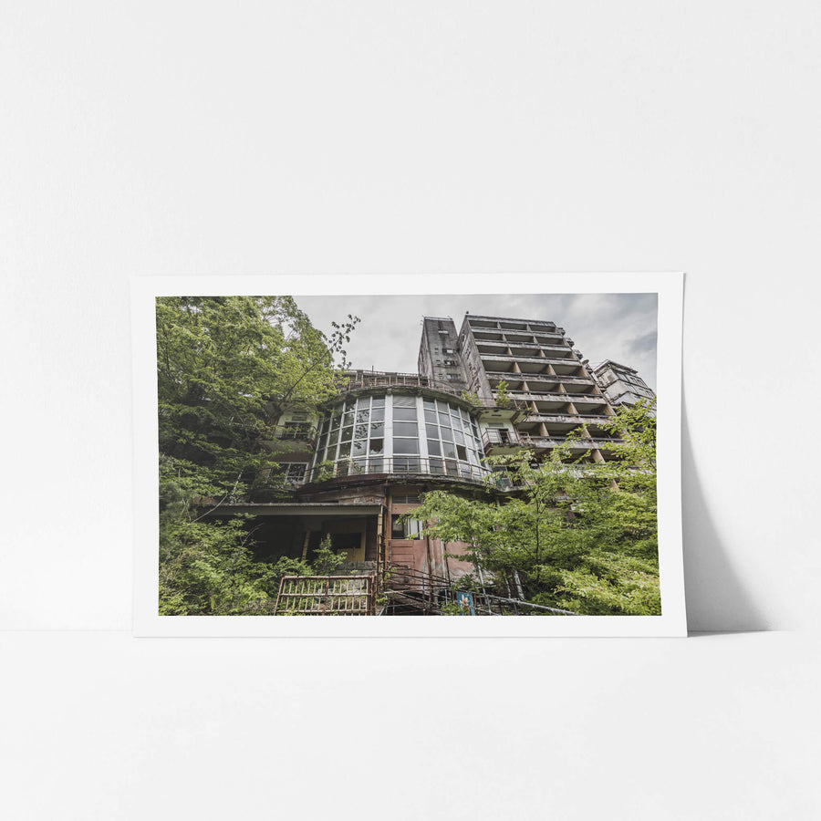 Kappa Onsen and Kinugawa Kan at Kinugawa Kan, a curved bay of windows juts from the lower facade of Kinugawa Kan.