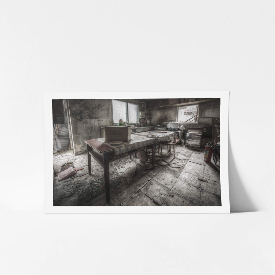 Kitchen And Dining Room at Kuwashima Hospital, a kitchen table sits centre-room, covered in a checked cloth gone grey.