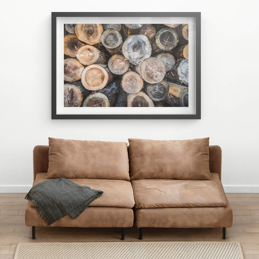 Log Stack at Landscapes, cut logs packed tight, end-grain facing out.