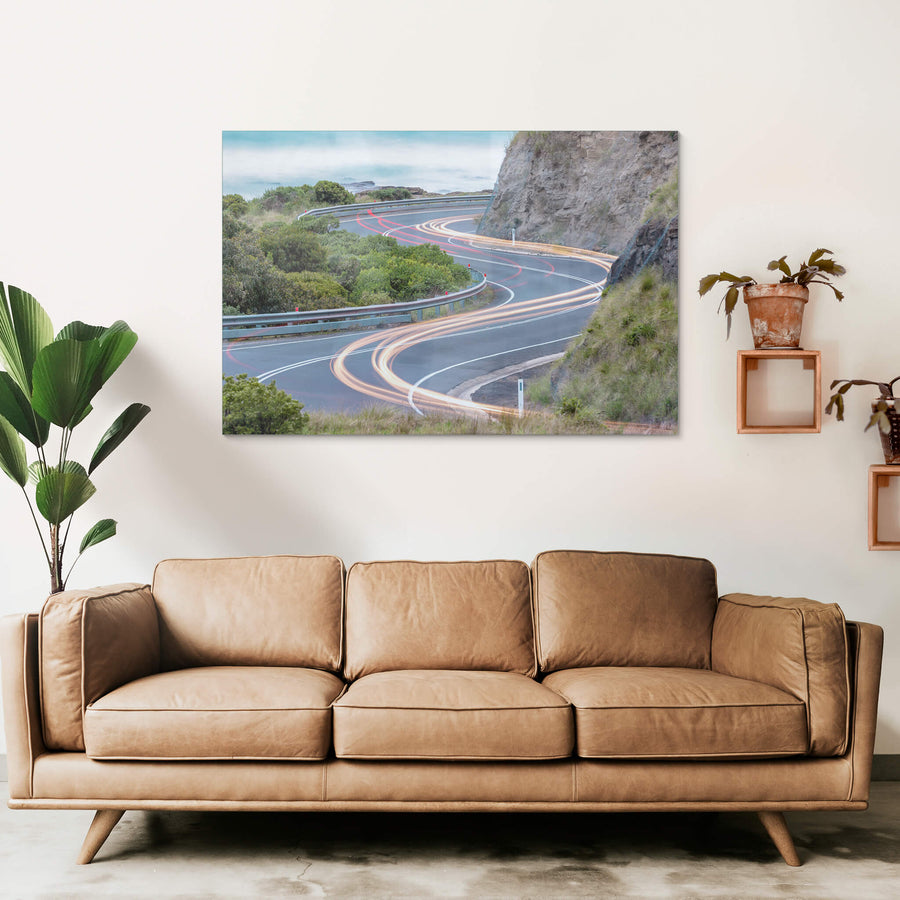 Meander at Landscapes, the Great Ocean Road winds through a cutting in the coastal rock face, the asphalt banking hard.