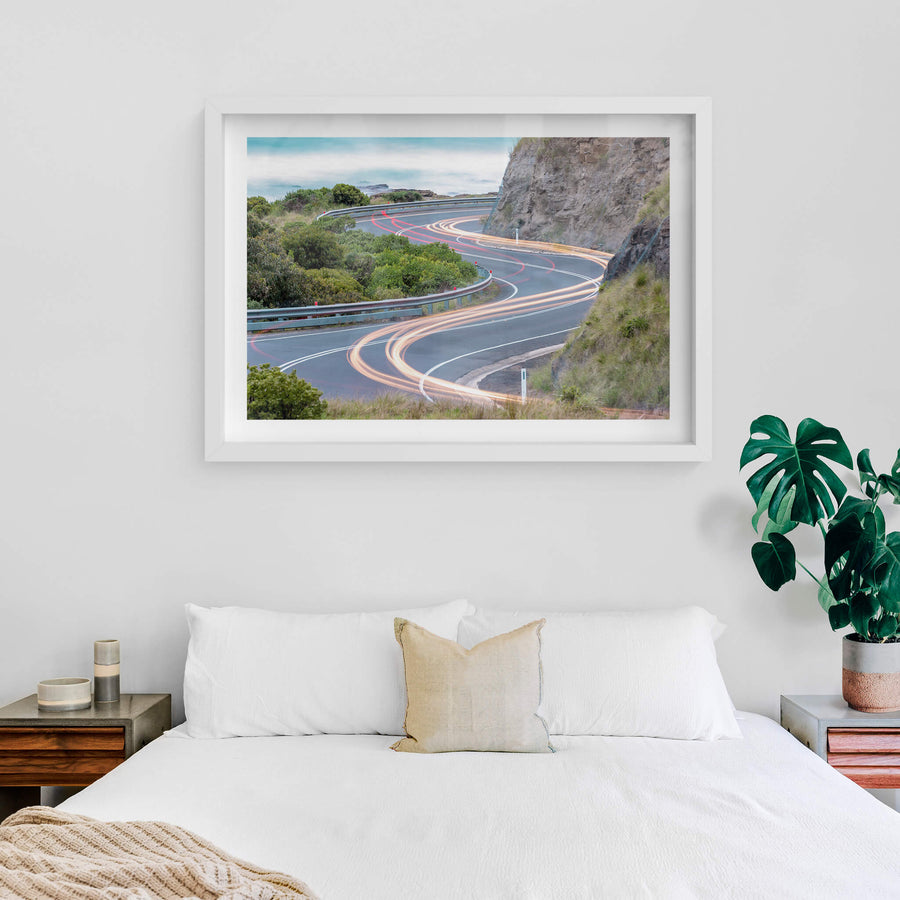 Meander at Landscapes, the Great Ocean Road winds through a cutting in the coastal rock face, the asphalt banking hard.
