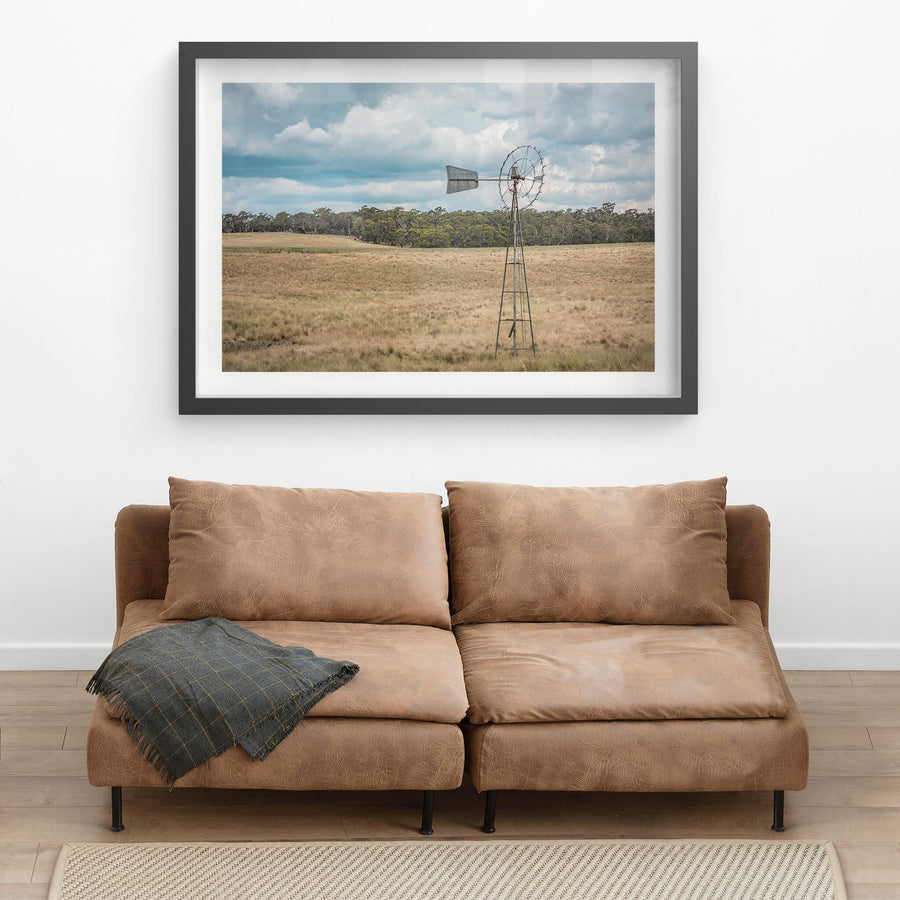Snowy Mountains Windmill at Landscapes, a lone windmill in a paddock on a cloudy afternoon.