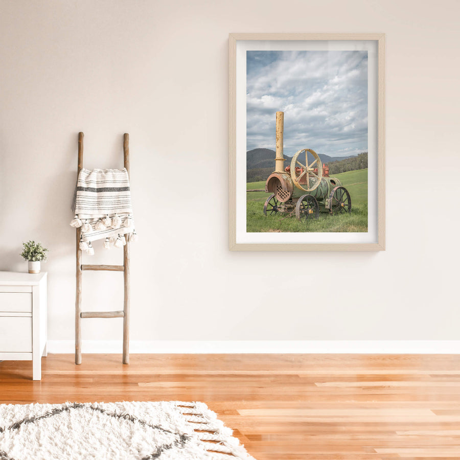 Steam Machine at Landscapes, a portable steam engine sits in open pasture, its iron wheels sunk into thick green grass.