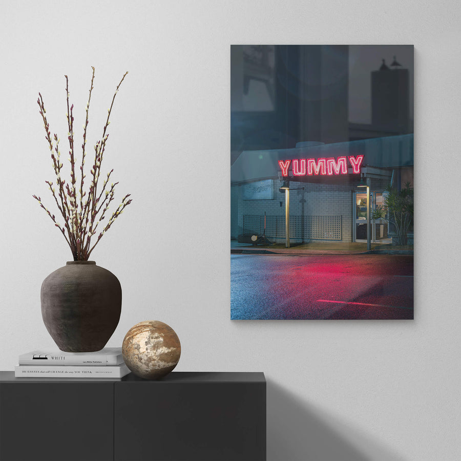 Yummy at Landscapes, red neon letters spell YUMMY across the flat roof of a single-storey brick shopfront.