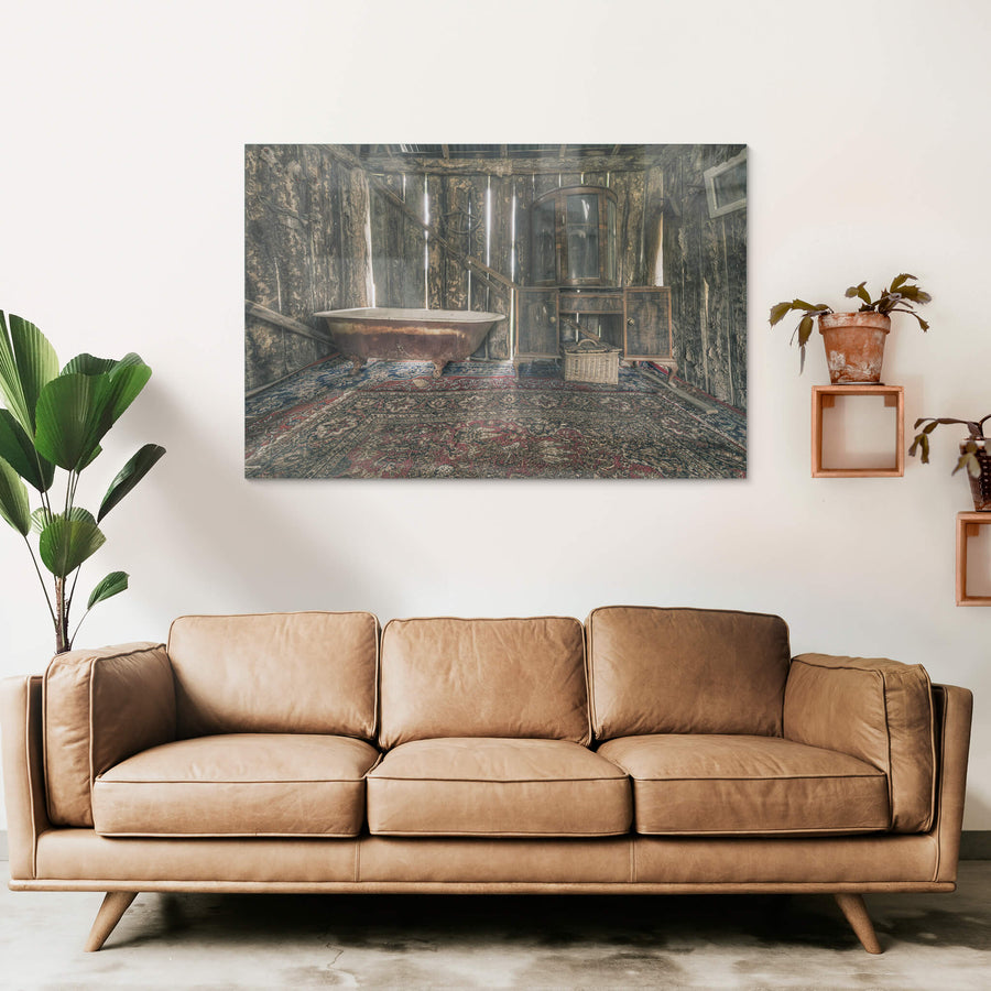 Bath at Leichhardt House, a cast-iron clawfoot bathtub sits on a Persian rug, its enamel interior stained brown with rust.